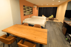 【ファミリールーム「だんらん」】2024年12月にリニューアルした新客室です。ゆったりとした畳スペースとイス・テーブルでもお寛ぎいただけるスペースがあります。お部屋食も可能ですのでご希望の際はご予約の際に備考欄にメッセージを残していただくか、お電話でお問い合わせくださいませ。その場合はお部屋食料金となるため、別途お一人様あたり2200円（税込）頂戴しております。予めご了承をお願い致します。