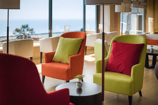 可愛らしいポップな色合いの明るい開放的なロビー。海を眺めながらのティータイムは至福の時間です。