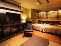 半露天風呂付スーペリアツインルーム／リビングにはロッキングチェアと暖炉を備えております。