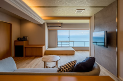 【半露天風呂付き洋室 ～汀乃音～】窓際で海を眺めながらほっと一息。まどろみスペース付きリビング