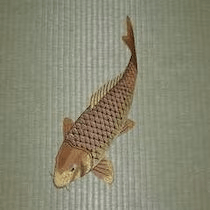 Embroidered tatami featuring black koi, displayed during the autumn season.